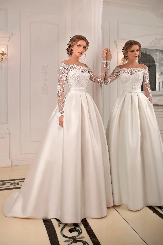 Wedding Dresses with Pleated Tulle Skirt and Sequined Geometric Shapes and Lace Overlay and Bow at the Waist for a Princess and Feminine LookAntonia Wedding Dresses with Pleated Tulle Skirt and Sequined Geometric Shapes and Lace Overlay and Bow at the Waist for a Princess and Feminine LookAntonia