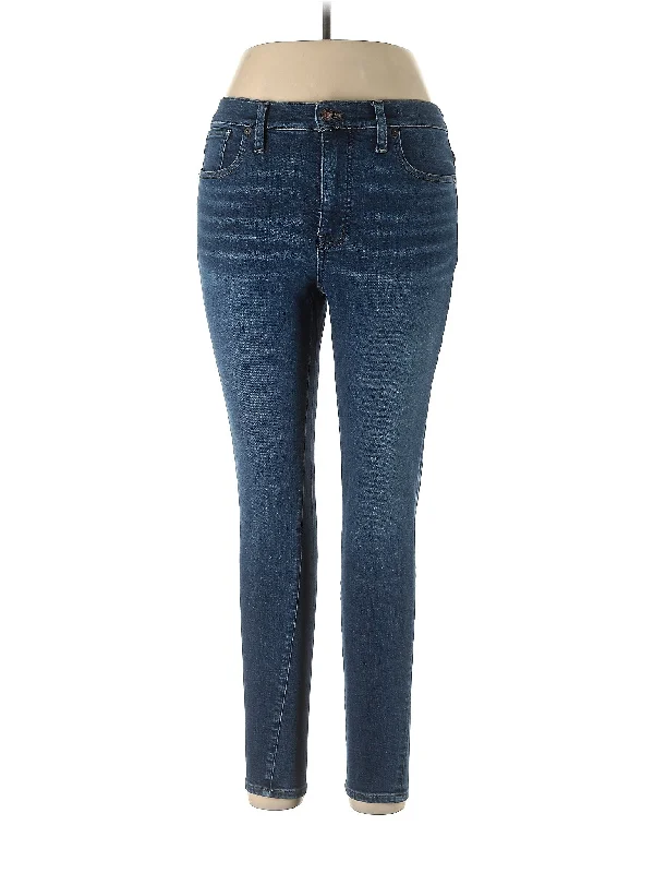 Ripped and torn denim jeans with multiple strategic holes for a rebellious styleMid-Rise Skinny Jeans in Dark Wash Ripped and torn denim jeans with multiple strategic holes for a rebellious styleMid-Rise Skinny Jeans in Dark Wash