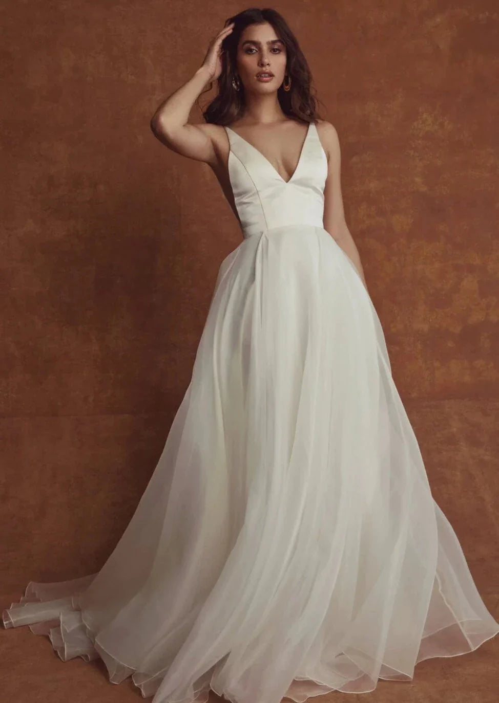 Wedding Dresses with Satin Trimmed Collar and Ruffled Hem and Bow at the Waist for a Classic and Girly LookSarah Seven Emilia Spaghetti Strap Wedding Dresses with Satin Trimmed Collar and Ruffled Hem and Bow at the Waist for a Classic and Girly LookSarah Seven Emilia Spaghetti Strap